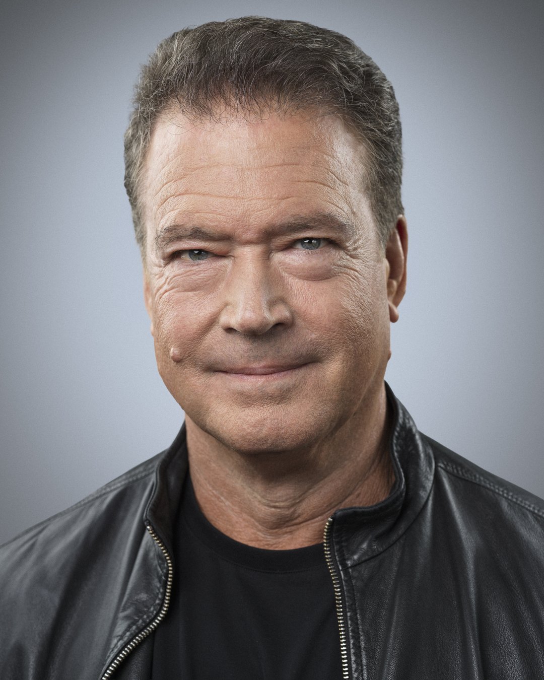 Curt Behlmer, Principal Consultant at In The Dark, Inc., wearing a black t-shirt and leather bomber jacket